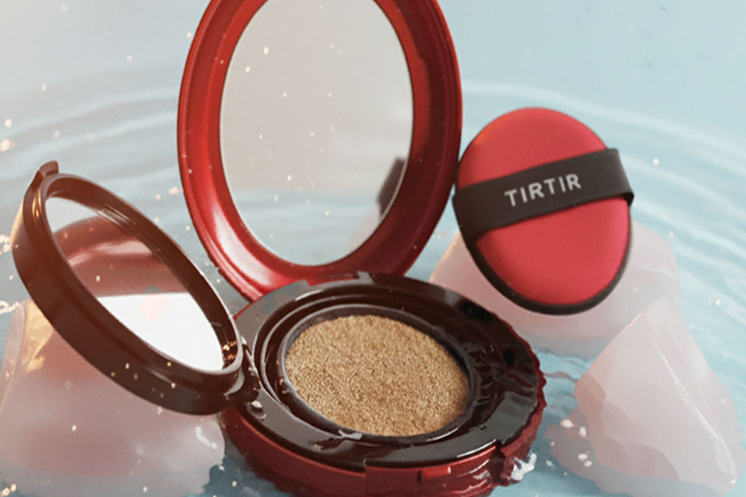 TIRTIR Mask Fit Red Cushion in the middle of glistening water and styled with rose quartz. 