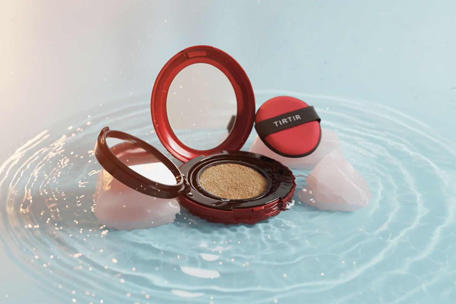 TIRTIR Mask Fit Red Cushion in the middle of glistening water and styled with rose quartz. 